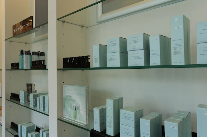 SkinCeuticals products on glass shelves at Dermis